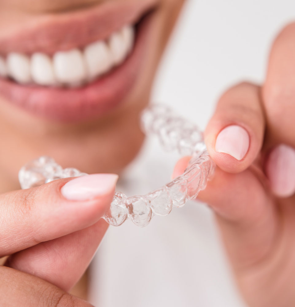 close up of person putting on their clear aligner