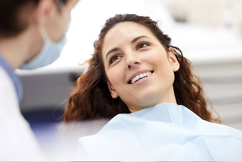 patient smiling brightly prep and ready for dental treatment